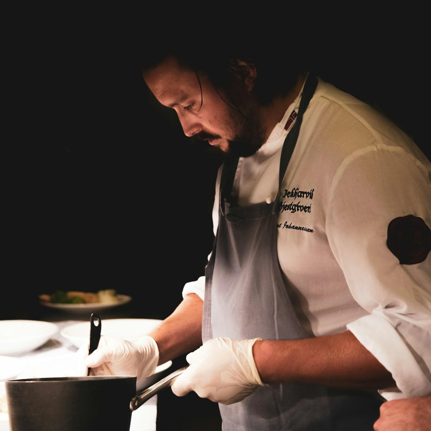 Community members collaborating in a modern cooking space, sharing recipes and techniques